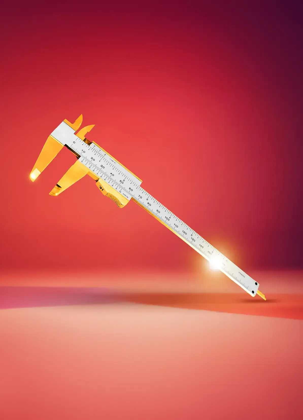 Ein weißer und gelber Messschieber wird vor einem leuchtend roten und rosafarbenen Hintergrund dargestellt, wobei die Ränder durch einen leuchtenden Lichteffekt hervorgehoben werden.